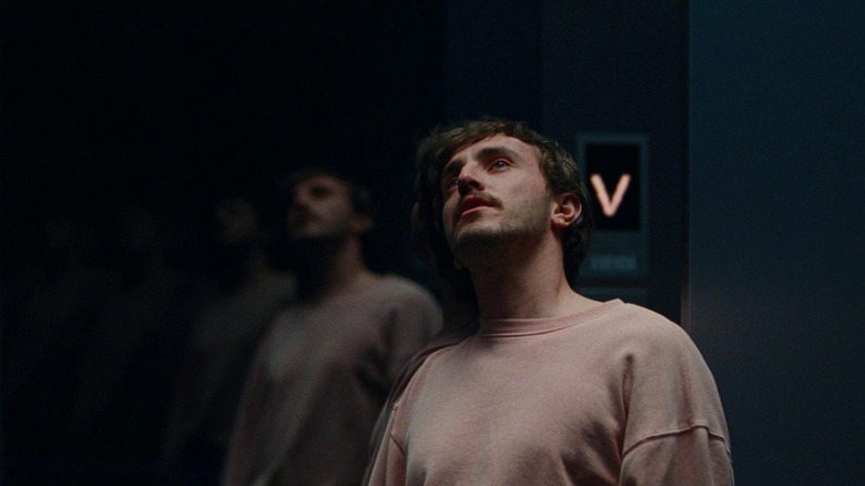 Paul Mescal as Henry in light-colored sweatshirt leaning against elevator wall in All of Us Strangers
