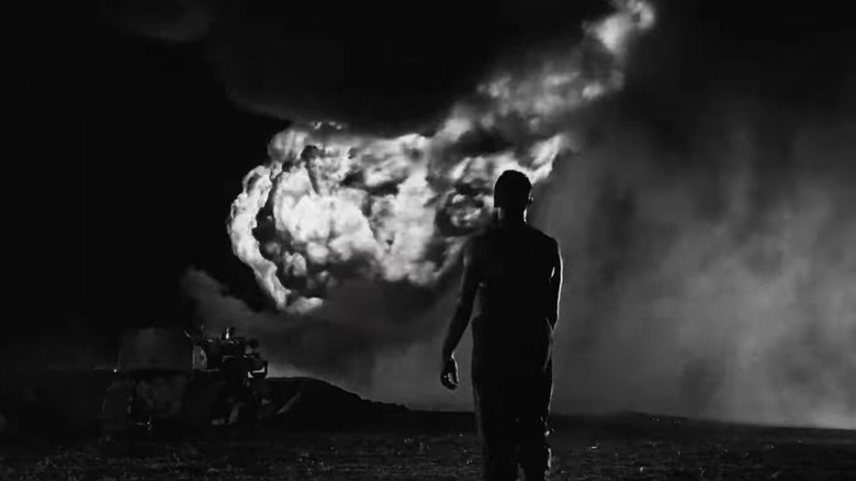 A man watches an explosion from a distance in The Wages of Fear