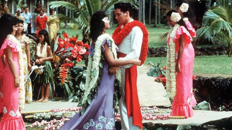 Elvis Presley as Chad Gates and Joan Blackman as Maile Duval getting married in Hawaii in Blue Hawaii.