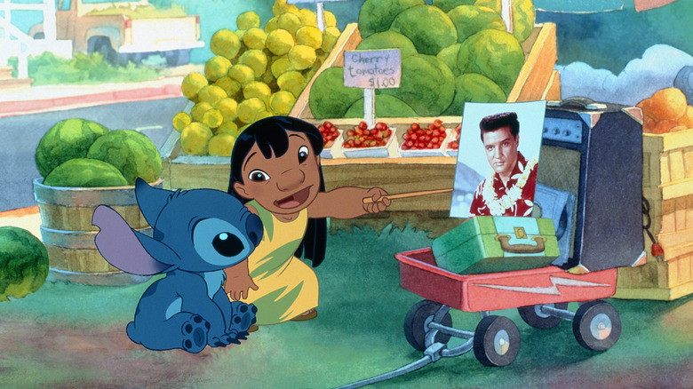 Lilo pointing at a picture of Elvis Presley in a fruit market speaking to Stitch in Lilo & Stitch.