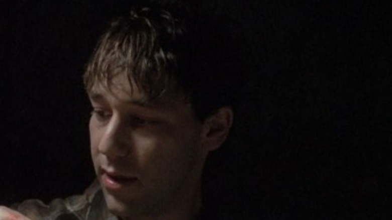Randy (Sam Raimi) looks at a piece of meat in Intruder