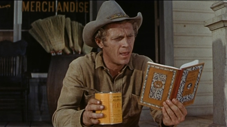 Max Sand (Steve McQueen) reads book in Nevada Smith
