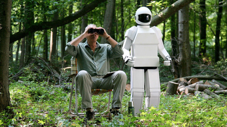 Frank Langella as Frank, sitting in the forest with his Robot in Robot and Frank