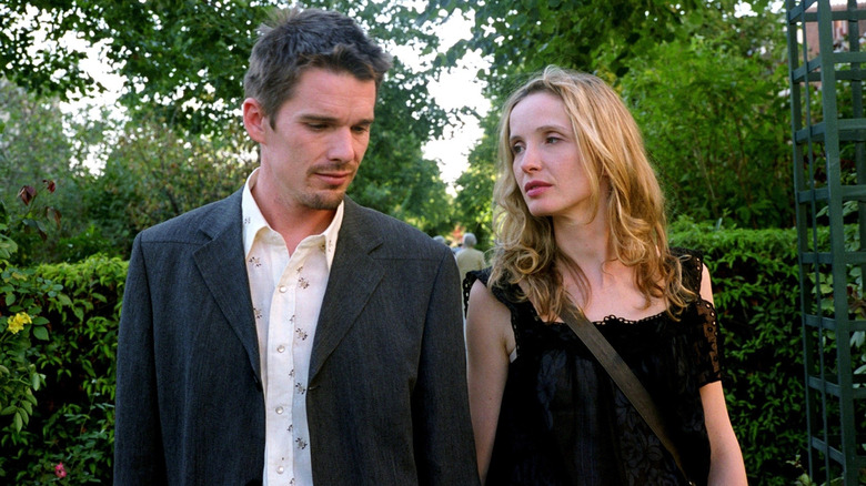 Ethan Hawke as Jesse and Julie Delpy as Céline take a walk in a garden in Before Sunset
