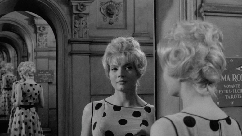 Corinne Marchand as Cléo looks in a mirror with her reflection repeating behind her Cléo from 5 to 7.s in