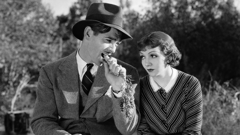 Clark Gable and Claudette Colbert as Peter Warne and Ellie Andrews putting up with each other on the side of the road in It Happened One Night