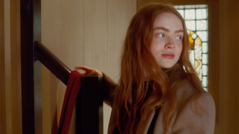 Sadie Sink as Her leaving a red scarf on a staircase in All Too Well: The Short Film