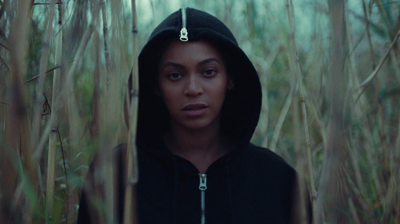 Beyonce Knowles wearing a hoodie in a field of bamboo in the Lemonade film