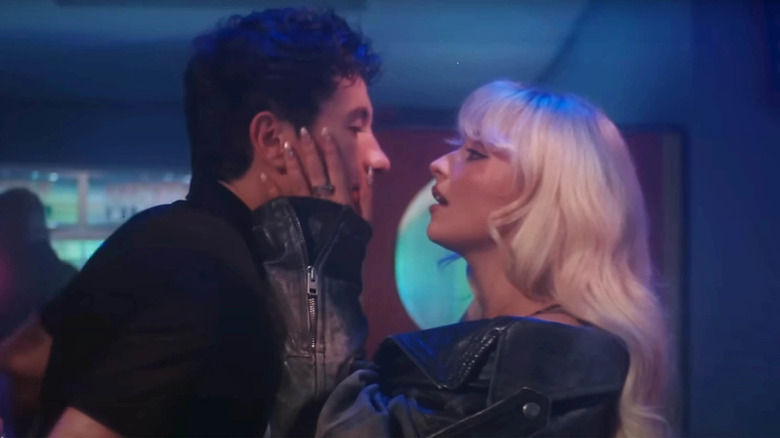 Sabrina Carpenter holding Barry Keoghan's face as he's arrested in the Please Please Please music video