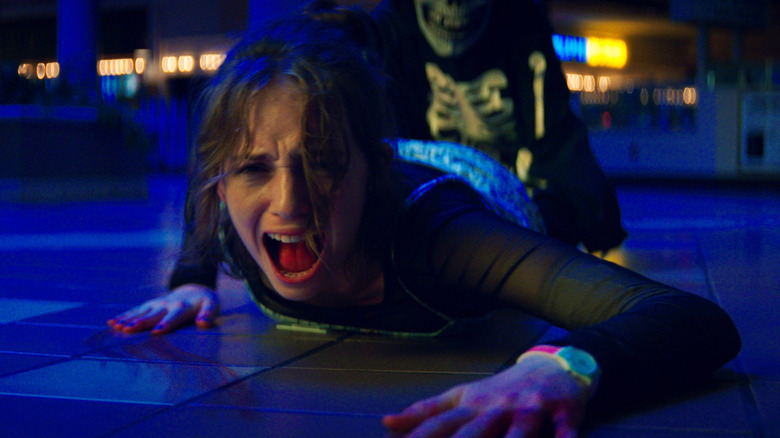 Heather (Maya Hawke) getting dragged away in Fear Street Part One: 1994