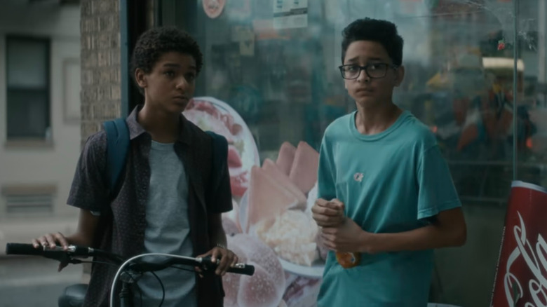 Miguel (Jaden Michael) and Luis (Gregory Diaz IV) by a shop in Vampires vs. the Bronx