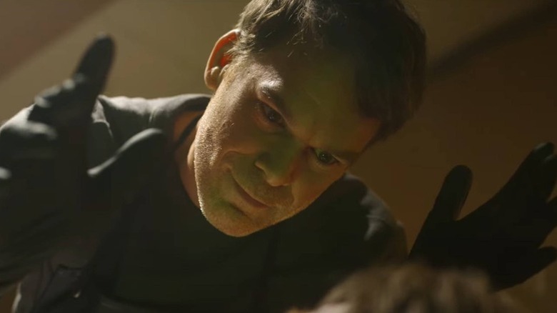 Dexter Morgan (Michael C. Hall) looms over a victim in Dexter: Resurrection