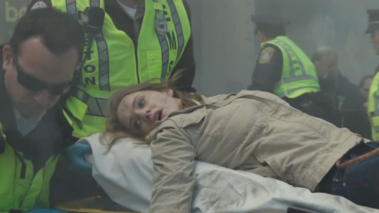 Jessica (Rachel Brosnahan) being carried away on a stretcher in Patriots Day