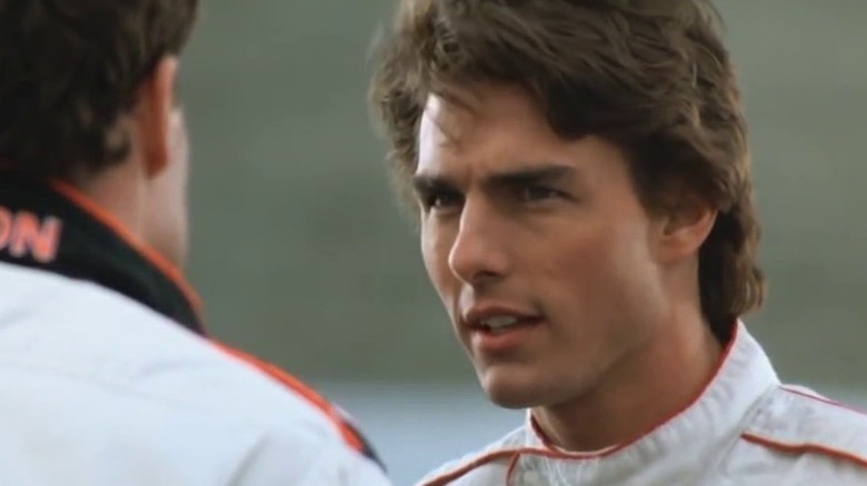 Cole Trickle (Tom Cruise) stars at his pit crew in Days of Thunder