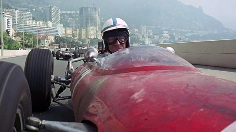 Jean-Pierre Sarti (Yves Montand) drives a red race car around Monaco in Grand Prix (1966)