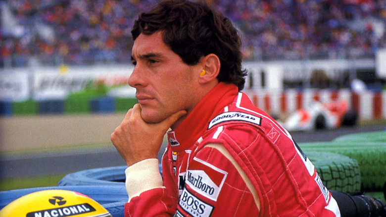 Ayrton Senna looks thoughtfully over a race track in Senna