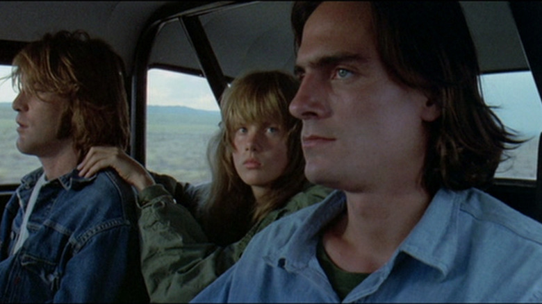 The Driver (James Taylor) drives stoically with the Mechanic (Dennis Wilson) and the girl (Laurie Bird) in Two-Lane Blacktop
