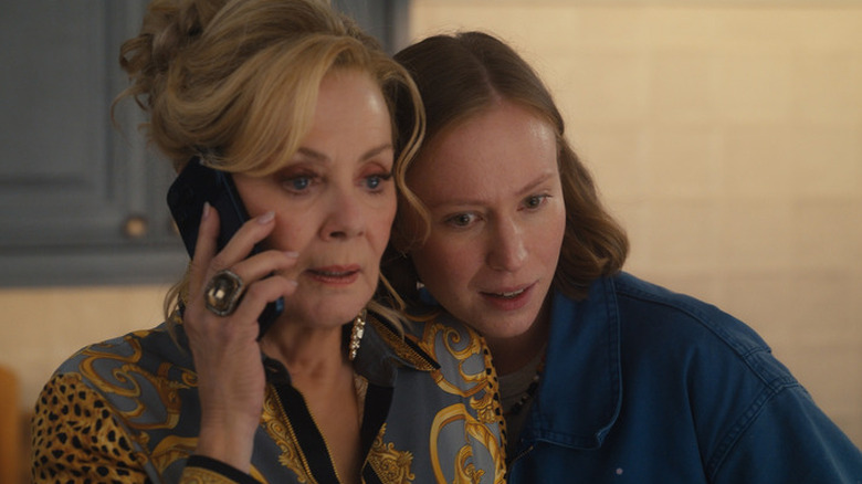 Ava Daniels (Hannah Einbinder) listens to Deborah Vance (Jean Smart) speak on a phone in Hacks