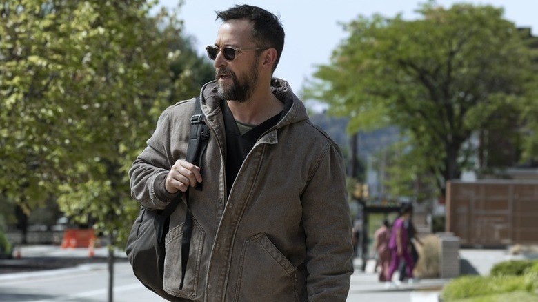 Robby Robinavitch (Noah Wyle) walks outside with a backpack in The Pitt