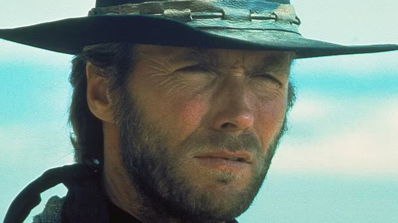 A close-up of Clint Eastwood as The Drifter in High Plains Drifter, with his trademark squint in a cowboy hat.