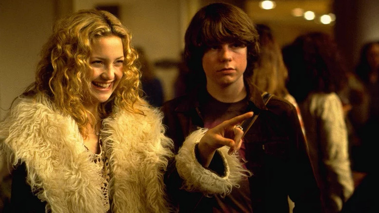 Penny Lane (Kate Hudson) smiles while pointing next to William Miller (Patrick Fugit) in Almost Famous