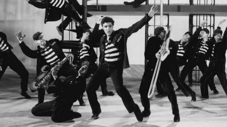 Vince Everett (Elvis Presley) dances on a faux prison stage with backup dancers in Jailhouse Rock
