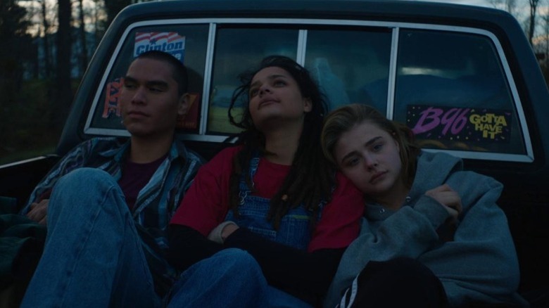 Forrest Goodluck as Adam Red Eagle, Sasha Lane as Jane Fonda, and Chloë Grace Moretz as Cameron Post sitting in the back of a pickup truck in The Miseducation of Cameron Post