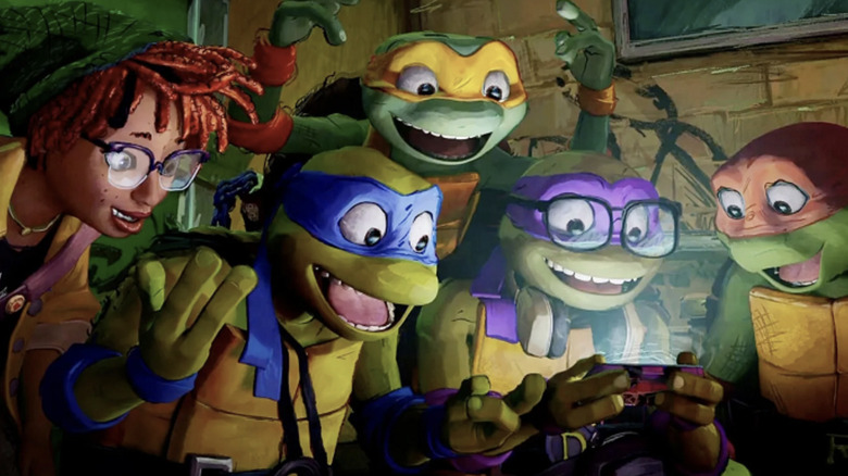 Ayo Edebiri as April O'Neil, Nicolas Cantu as Leonardo, Shamon Brown Jr. as Michelangelo, Micah Abbey as Donatello, and Brady Noon as Raphael all smiling and looking at a screen in Teenage Mutant Ninja Turtles: Mutant Mayhem (2023)
