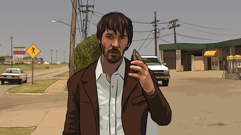 Bob Arctor (Keanu Reeves) speaks on a phone while walking down a road in A Scanner Darkly