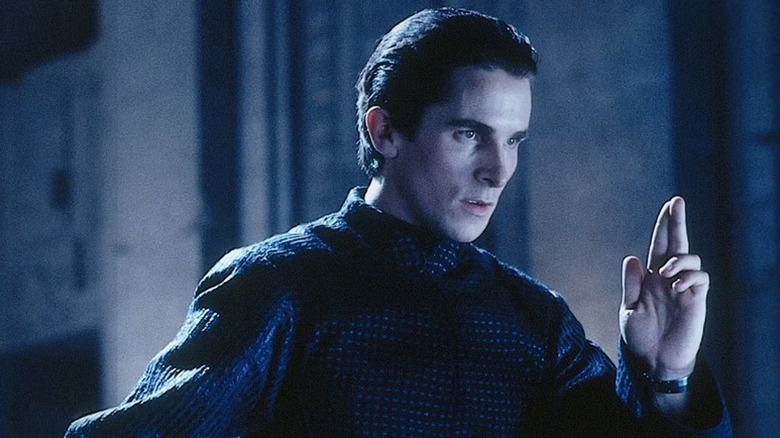 John Preston (Christian Bale) poses with two fingers up in Equilibrium