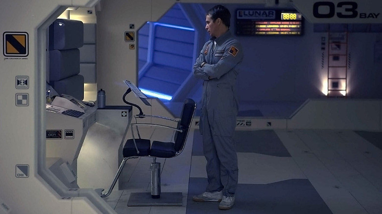 Sam Bell (Sam Rockwell) looks at a computer in Moon (2009)