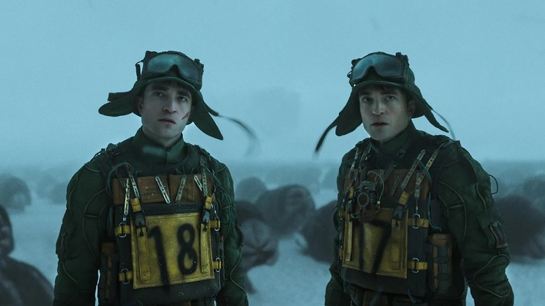 Mickey 18 and 17 in the snow on Niflheim wearing hats with goggles in Mickey 17