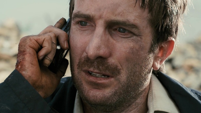 Wikus van de Merwe (Sharlto Copley) speaks on a cellphone in District 9