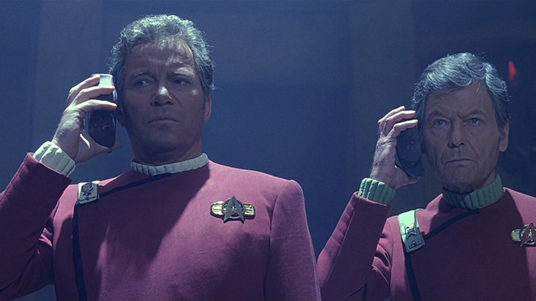 James T. Kirk (William Shatner) and Leonard McCoy (DeForest Kelley) listen to translation devices in Star Trek VI: The Undiscovered Country