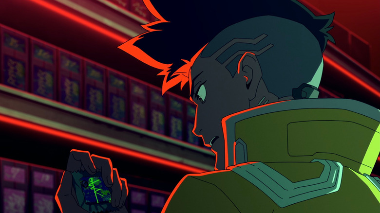 David (KENN) looking at a computer chip on Cyberpunk: Edgerunners