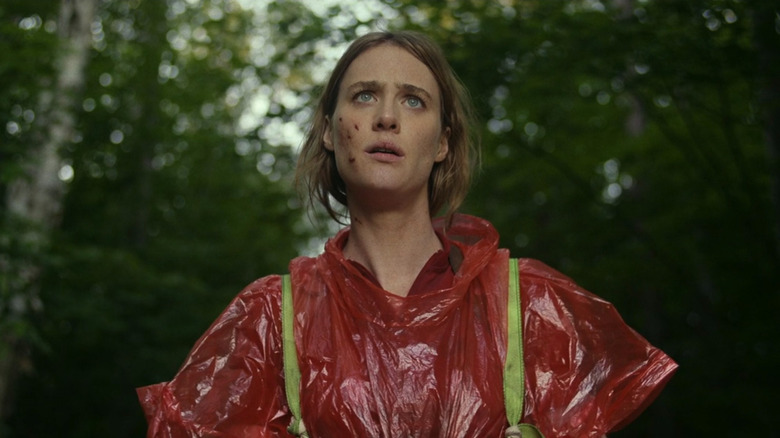 Kirsten Raymonde (Mackenzie Davis) wearing a red poncho in the woods on Station Eleven