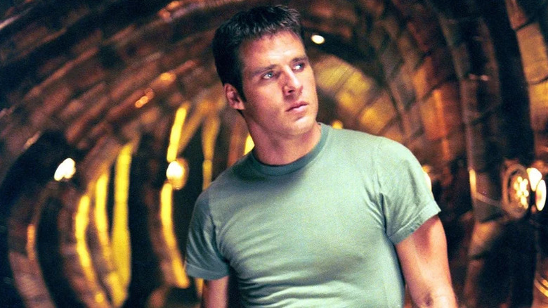 John Crichton (Ben Browder) stands in a spaceship in Farscape