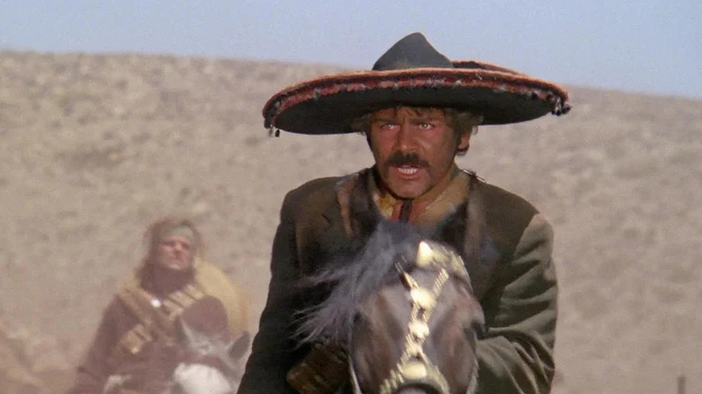 El Chuncho Muños (Gian Maria Volonté) rides a horse with his gang in A Bullet for the General
