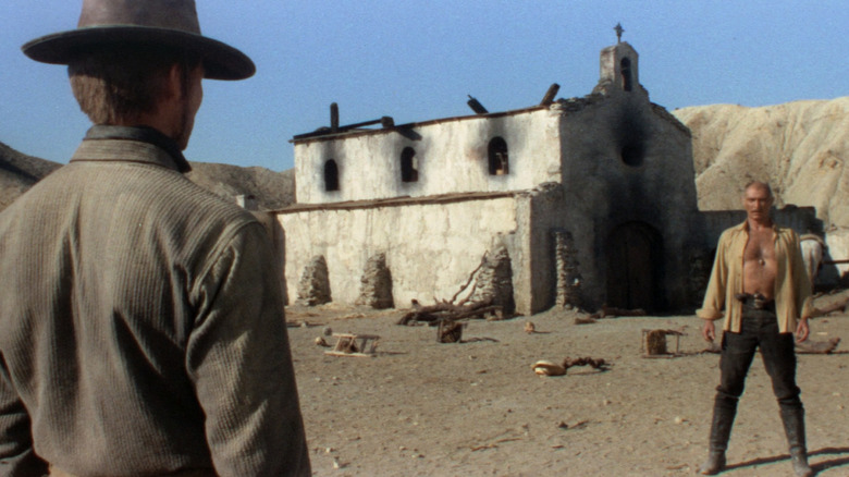 Bill (John Philllip Law) faces an open-shirted Ryan (Lee Van Cleef) in Death Rides a Horse