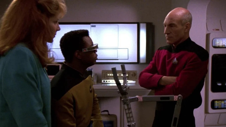 Beverly Crusher (Gates McFadden) and Geordi La Forge (LeVar Burton) speak with Jean-Luc Picard (Patrick Stewart) in Star Trek: The Next Generation
