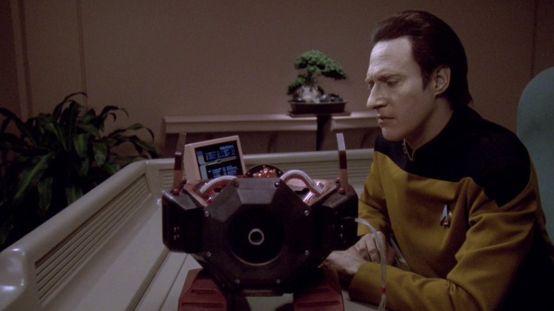 Data (Brent Spiner) examines an Exocomp in Star Trek: The Next Generation