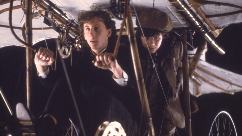 Sherlock Holmes (Nicholas Rowe) and John Watson (Alan Cox) in flying contraption in Young Sherlock Holmes