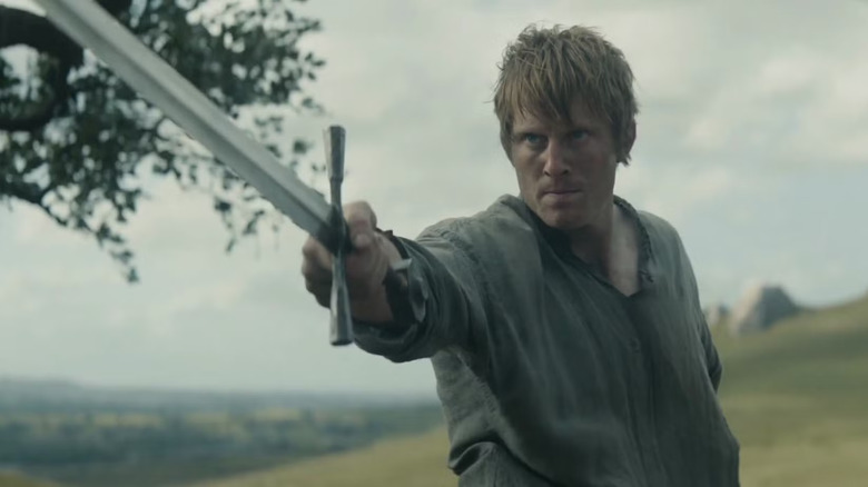 Peter Claffey as Ser Duncan "Dunk" the Tall in A Knight of the Seven Kingdoms, wielding a sword outside.