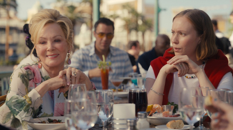 Jean Smart as Deborah Vance and Hannah Einbinder as Ava Daniels in Hacks, sitting at an outdoor meal together.