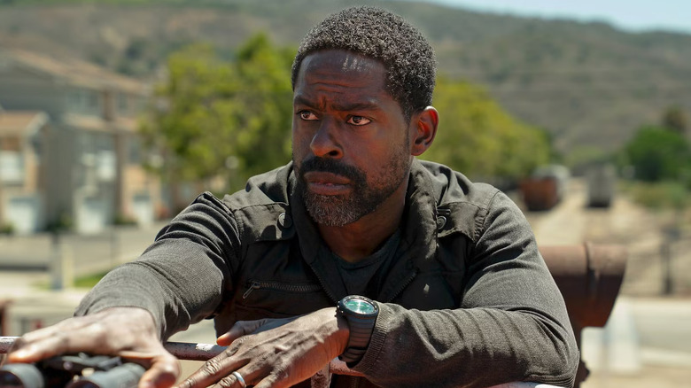 Sterling K. Brown as Xavier Collins in Paradise, looking off while holding on to a pair of binoculars.