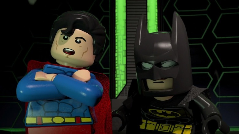 Superman (Travis Willingham) folds his arms next to Batman (Troy Baker) in Lego Batman: The Movie - DC Super Heroes Unite