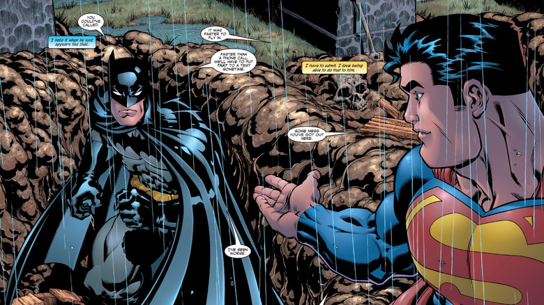Batman and Superman talk in the rain