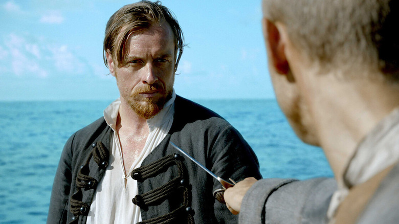 James Flint (Toby Stephens) looks nonplussed as a rapier is pointed at him in Black Sails