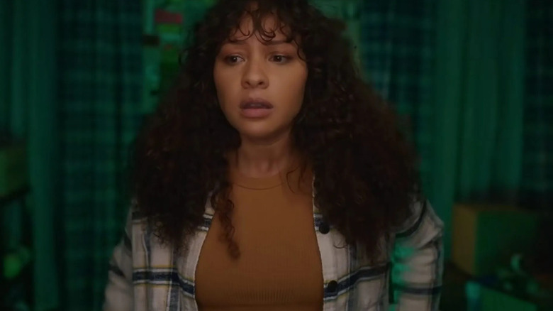 Ashley Rose (Jasmine Cephas Jones) stands uneasily in a darkened room in Blindspotting
