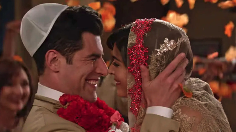 Cece Parikh (Hannah Simone) and Schmidt (Max Greenberg) move in to kiss at their wedding in New Girl